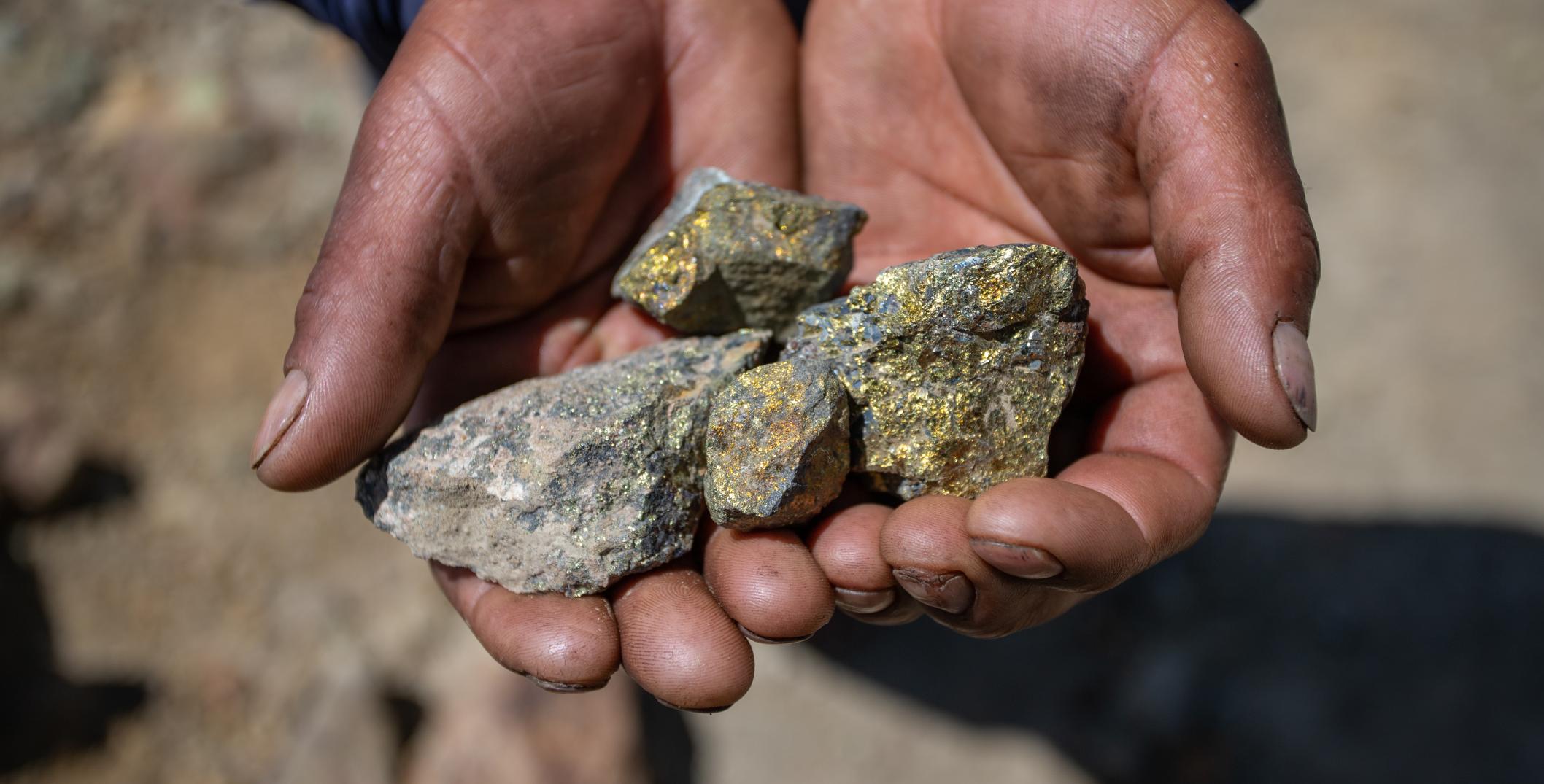 A member of Huancuire community holding copper in hands in Challhuahuacho, Peru