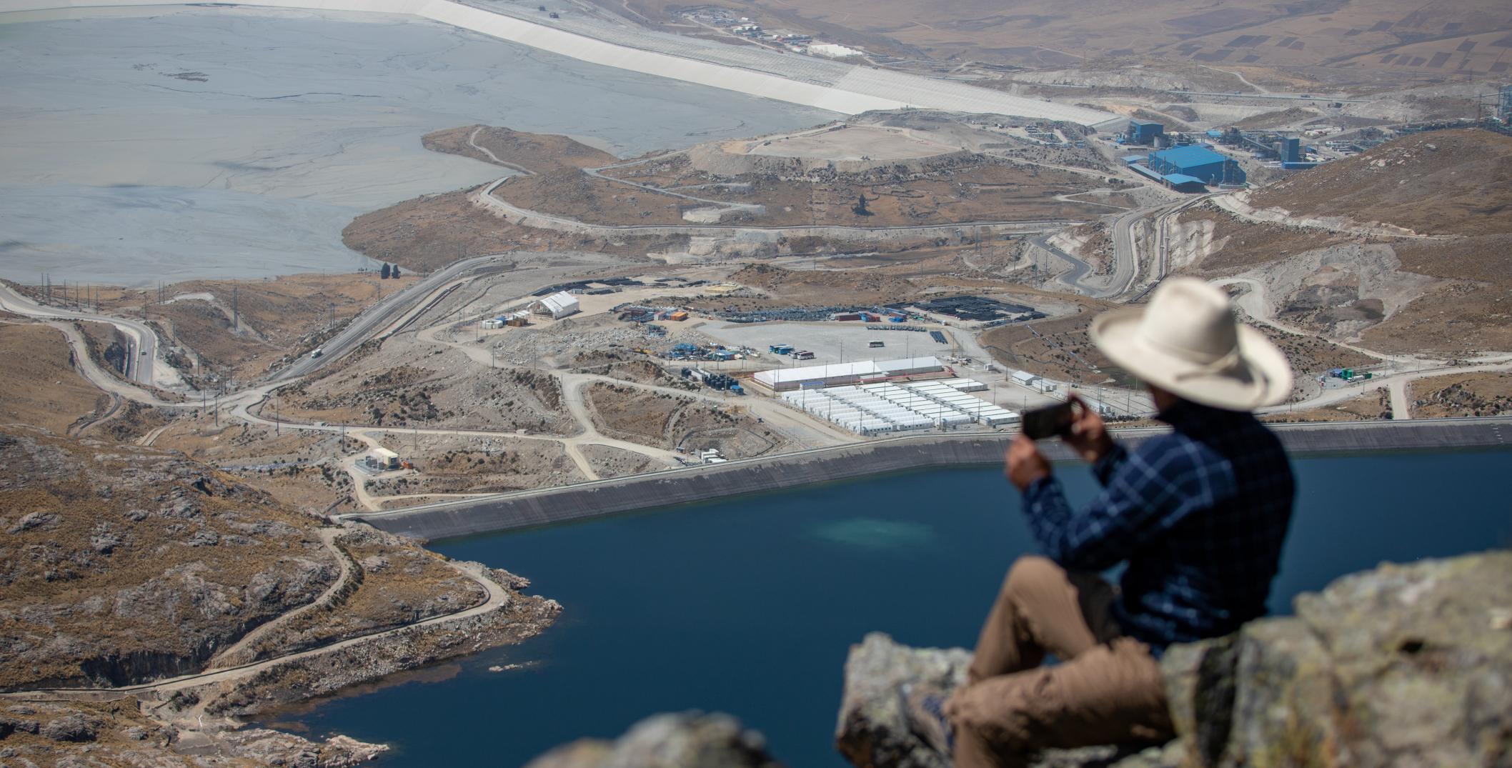 Man photographing copper mine in Challhuahuacho, Peru