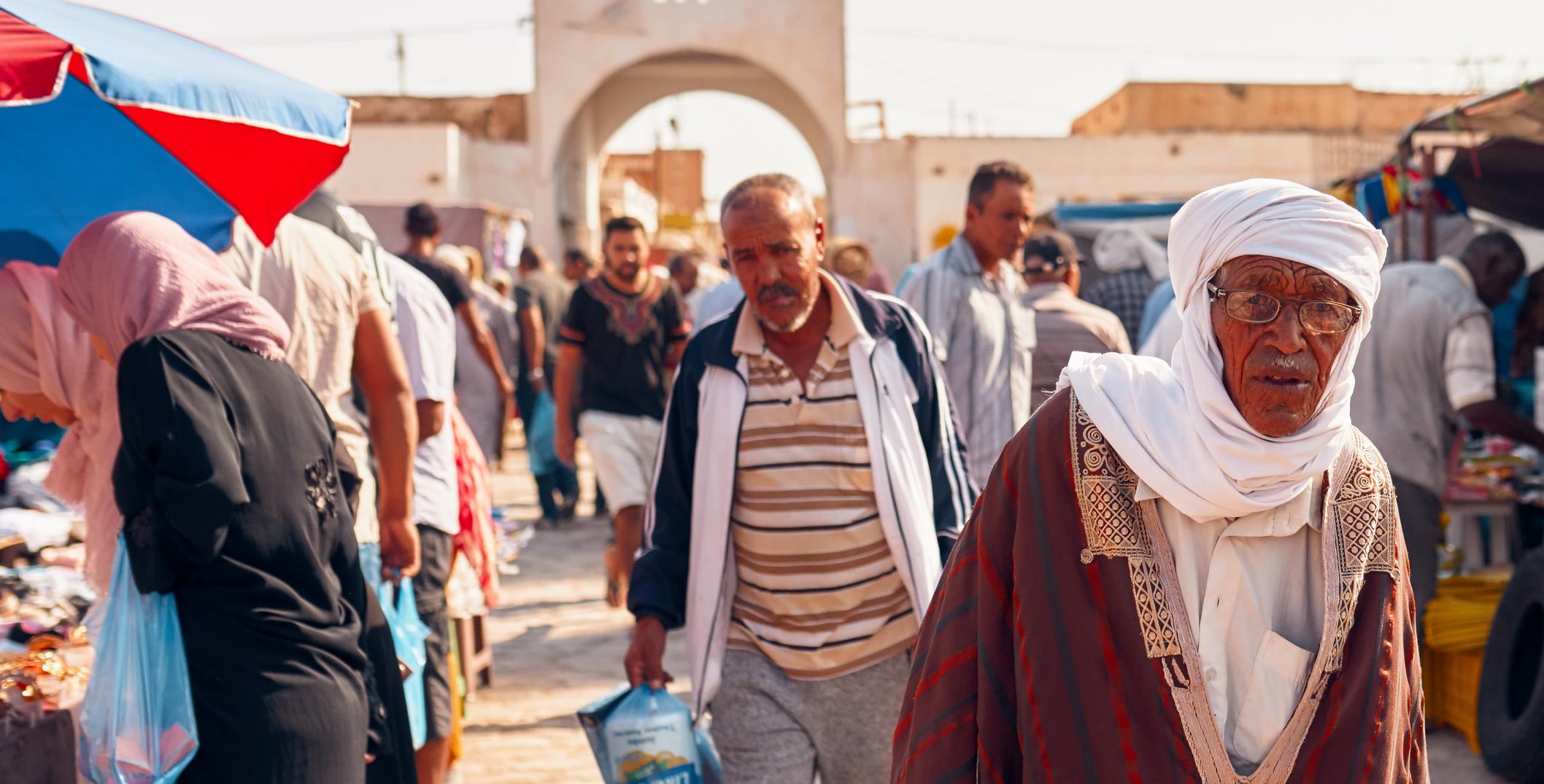 Men in traditional Tunisian clothes in Douz market, Tunisia