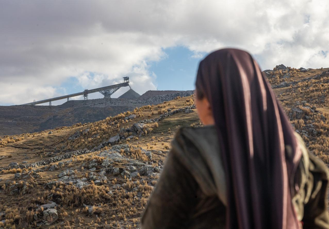 Woman looking at copper mine in Chicnahui, Challhuahuacho, Peru