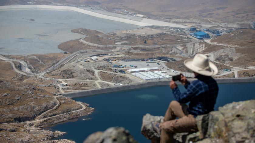 Man photographing copper mine in Challhuahuacho, Peru