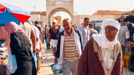Men in traditional Tunisian clothes in Douz market, Tunisia
