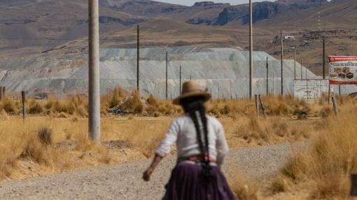 Woman walking toward a copper mine in Challhuahuacho, Peru